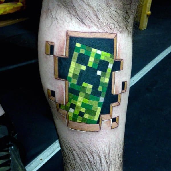 Realistic Minecraft Creeper tattoo on the calf, with a 3D pixelated effect that makes it appear as though it’s bursting through the skin.
