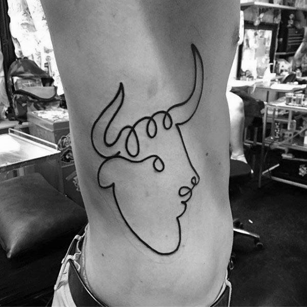 Minimalist ribcage tattoo of a bull in Picasso’s single-line style, capturing strength and elegance with a continuous flowing outline.
