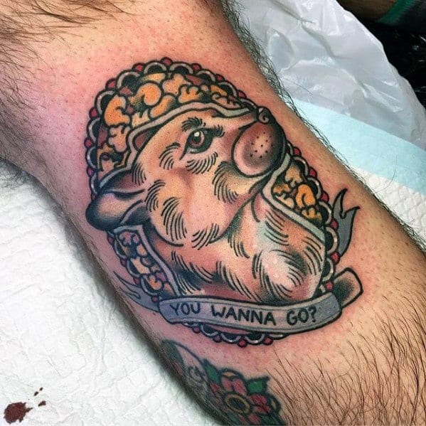 Tattoo of a fierce-looking dog framed by popcorn, with a banner that says YOU WANNA GO? in bold traditional style.