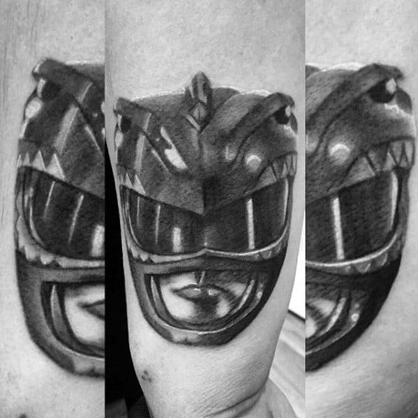 Black and grey tattoo of the Red Ranger helmet with intense shading, strong highlights, and a bold, realistic finish.