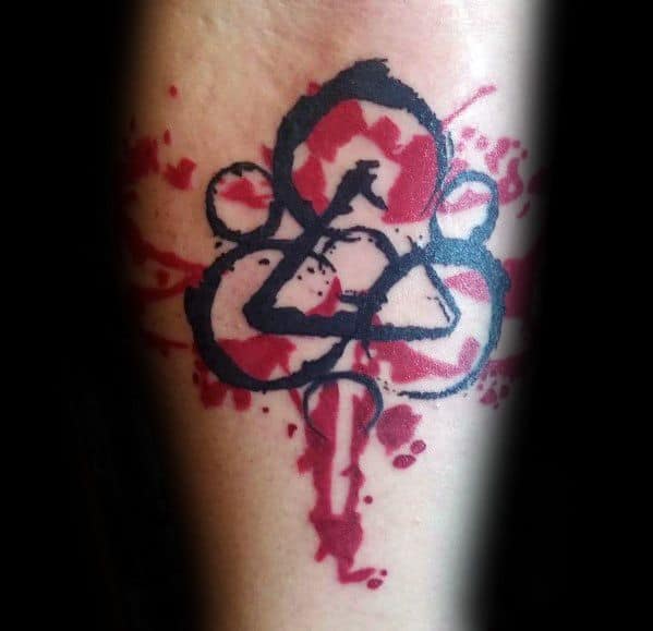 Coheed and Cambria Keywork tattoo with bold black lines and intense red splatter effect for a dramatic, high-contrast look.