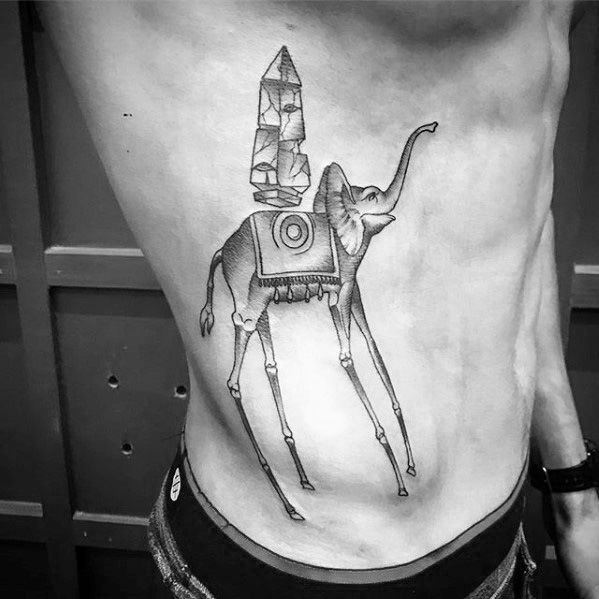 Black and grey Salvador Dali-inspired tattoo of a surreal elephant with elongated legs and a geometric obelisk, inked on the side of the torso.