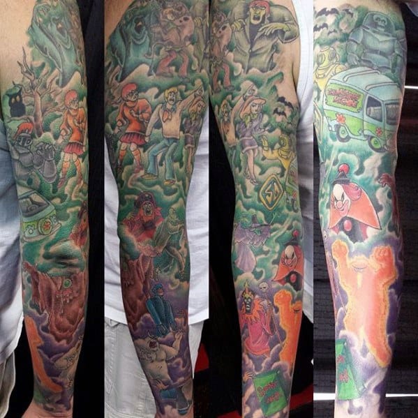 Full sleeve tattoo of the Scooby-Doo gang surrounded by classic villains, the Mystery Machine, and eerie mist in a haunted forest scene.