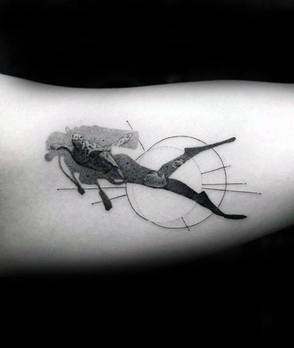 Black and grey scuba diver tattoo with geometric lines and dot shading, blending realism with abstract design.