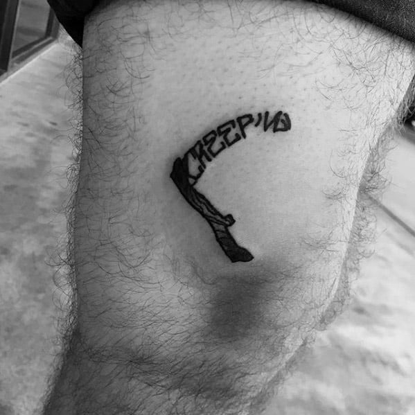 Male With Cool Scythe Creeping Word Thigh Tattoo Design