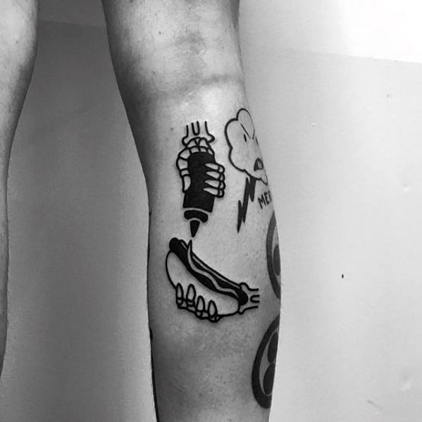 Tattoo of a hand holding a mustard bottle with a hot dog illustration, complemented by a cloud and lightning bolt design in black ink.