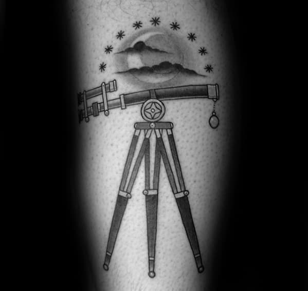 Telescope tattoo featuring a tripod under a cloud, moon, and stars