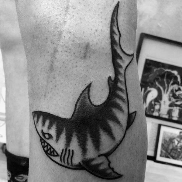Simple blackwork tiger shark tattoo with bold stripes, a rounded body, and sharp teeth in a minimalist traditional style.
