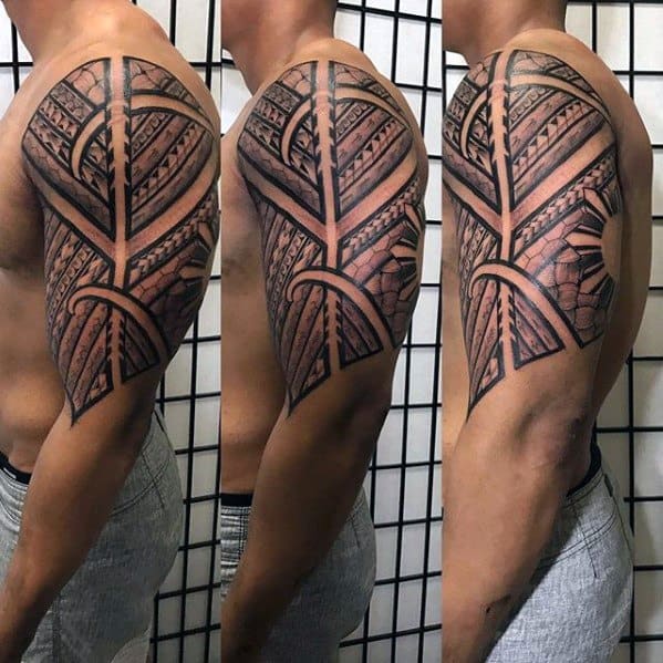Filipino sun tattoo on the upper arm with detailed tribal bands, symmetrical patterns, and a sun partially hidden by bold geometric lines.