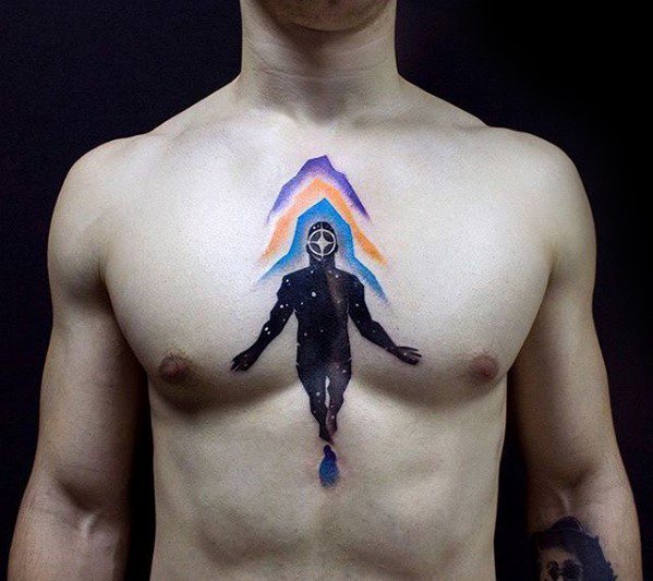 Surreal chest tattoo of a hooded cosmic figure floating upward, with colorful light beams forming a triangular aura above.