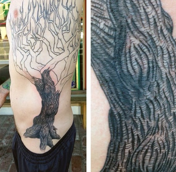 Male With Dark Trunk Oak Tree Tattoo On Side Ribs