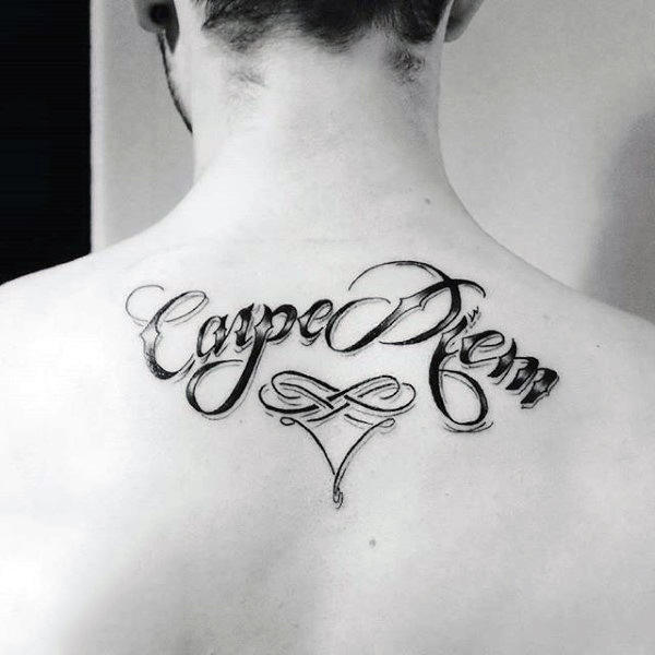 Male With Decorative Carpe Diem Lettering Tattoo On Upper Back