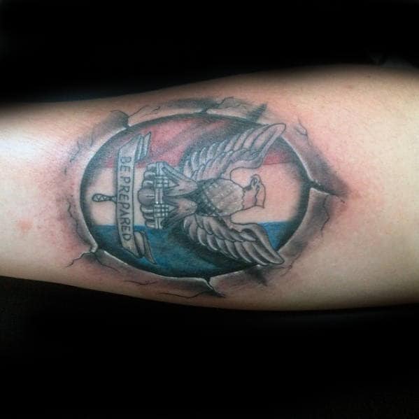 Male With Eagle Scout Badge Stone Outer Forearm Tattoo