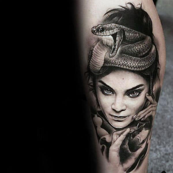 Male With Female Holding Apple With Snake Leg Calf Tattoos