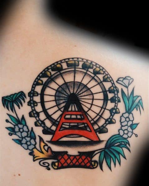 Traditional-style Ferris wheel tattoo with bold black outlines, vibrant red and yellow accents, and floral elements for a classic and decorative look.