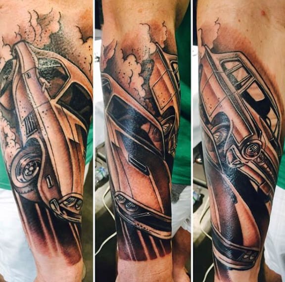 A detailed tattoo of a vintage car displayed on a forearm