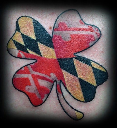 Shamrock-shaped tattoo filled with the Maryland flag pattern, blending Irish heritage with state pride in a bold and colorful design.