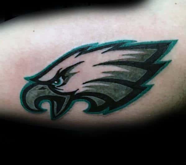 Male With Philiadephia Eagles Logo Tattoo On Bicep