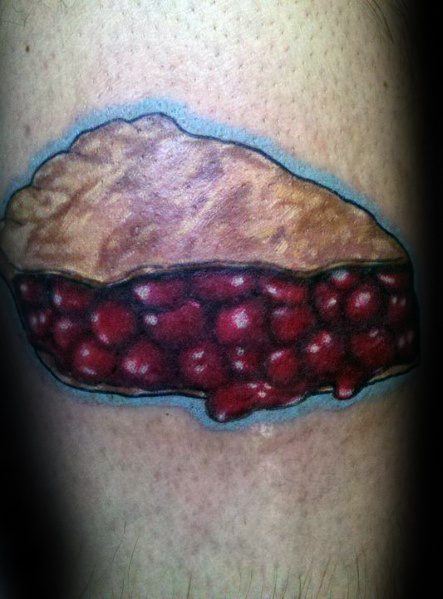 Realistic cherry pie slice tattoo with a golden crust and juicy filling, featuring bold shading for a vibrant and delicious-looking design