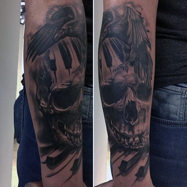 Male With Raven Skull And Piano Keys Tattoo Forearms