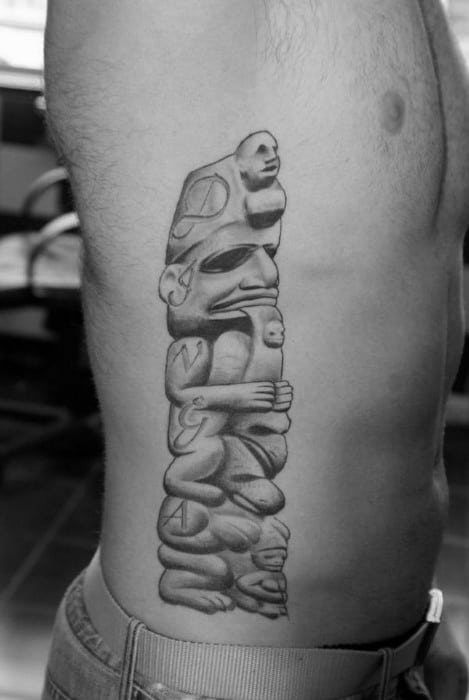 Male With Realistic Stone Totem Pole Shaded Dark Ink On Side Tattoo