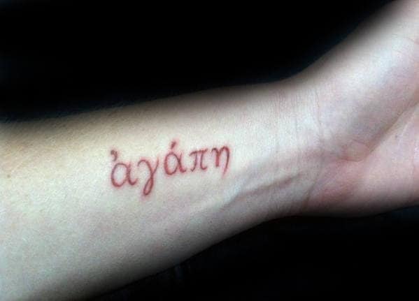 Male With Red Ink Agape Wrist Tattoo