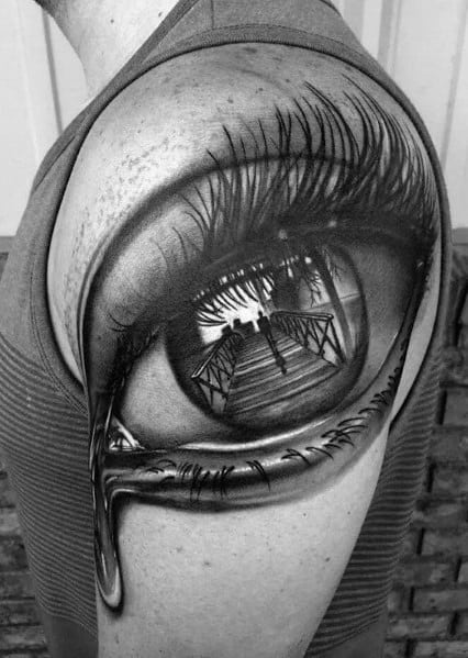 Tattoo of a realistic eye with a reflection of a stairway, enhanced with intricate shading and a surreal dripping effect for depth.