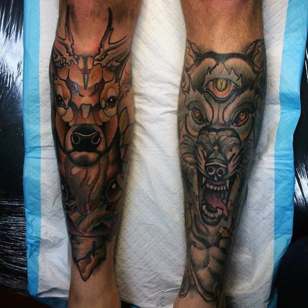 Male With Shin Tattoos Of Deer And Wolf