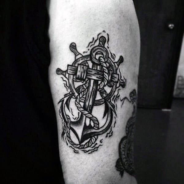 Male With Ship Wheel Wrapped Around Anchor Tattoo On Back Of Forearm