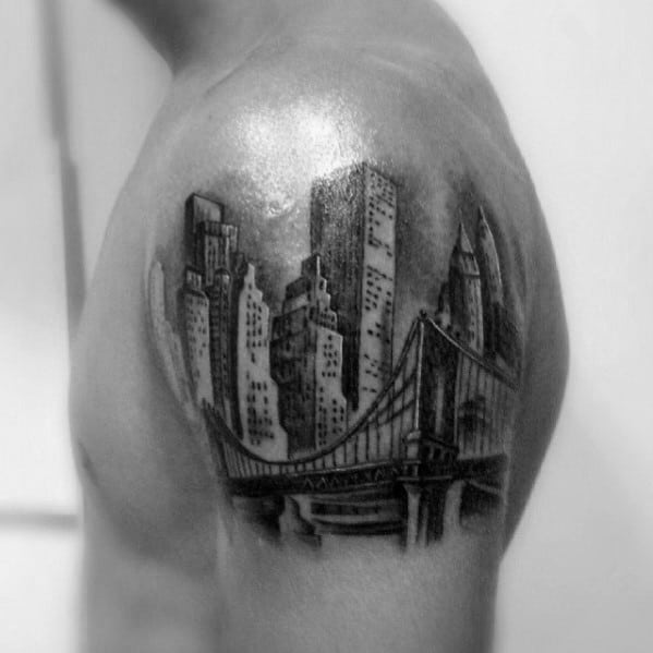 Male With Skyline Upper Arm Tattoo