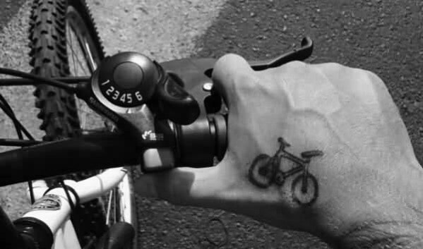 Male With Small Bicycle Tattoo On Hand