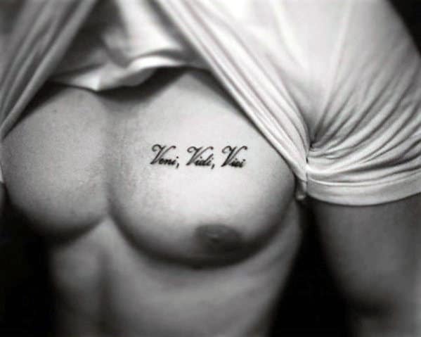 Male With Small Veni Veni Vici Words Upper Chest Tattoo
