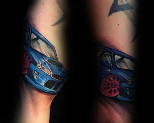 Colorful Subaru WRX STI tattoo on the forearm, featuring a vibrant blue body with striking pink wheels in a dynamic racing pose.