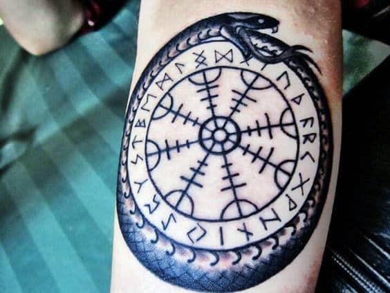 Male With Tattoo Of Norse Ouroboros Design On Inner Forearm