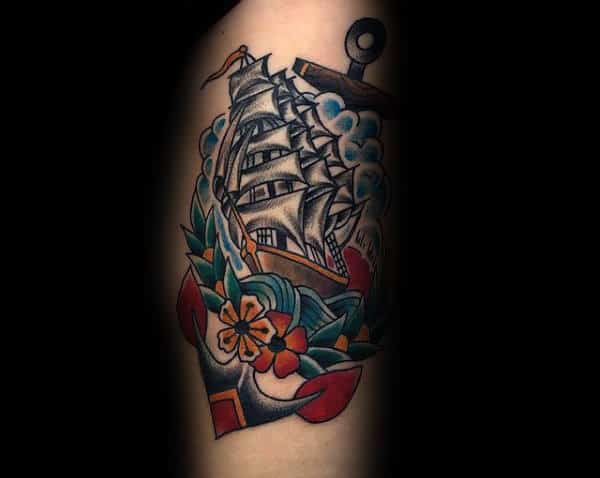 Male With Tattoo Of Traditional Anchor And Sailing Ship At Sea Arm Tattoo