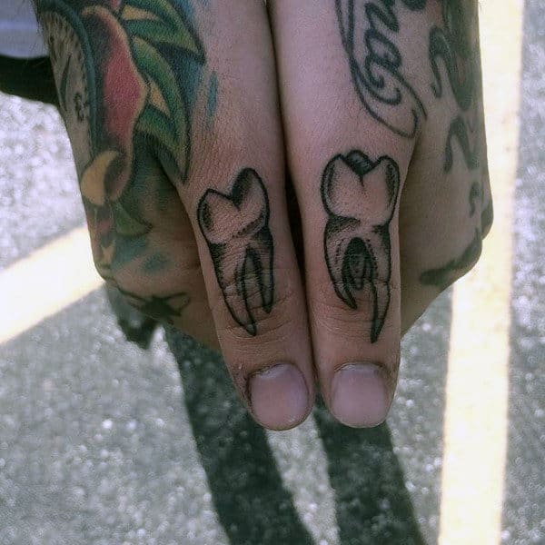 Male With Thumb Tattoo Of Teeth
