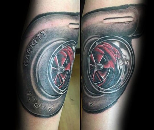 Realistic Garrett turbocharger tattoo on the forearm with detailed shading and red turbine blades, symbolizing speed, power, and automotive passion.