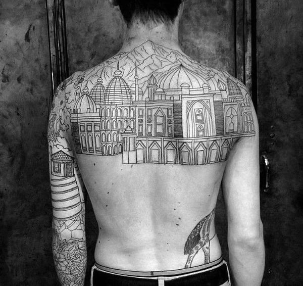 Male With Upper Bakc Tattoo Of Buildings