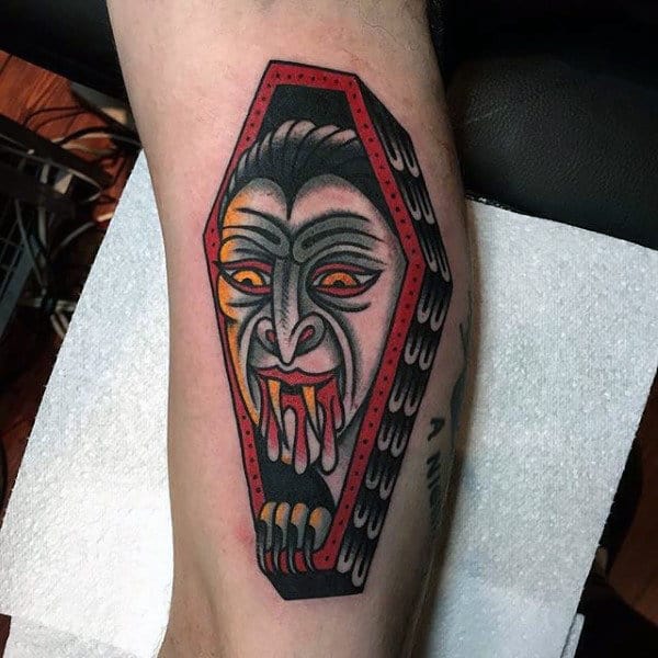 Male With Vampire Bites Tattoo And Casket On Forearm