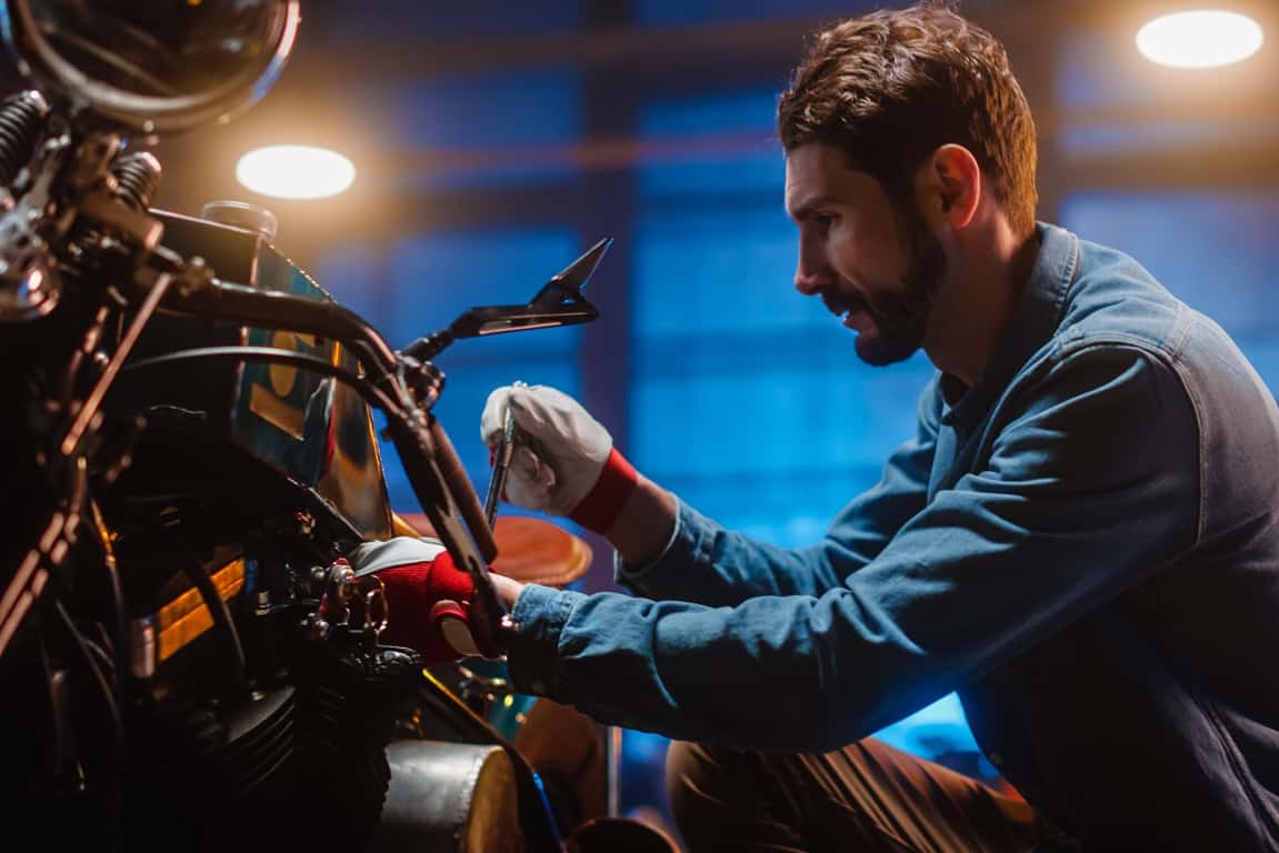 man building motorcycle