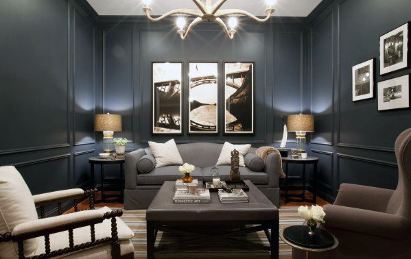Grey daybed couch in a sophisticated dark-walled living room with modern art and ambient lighting.
