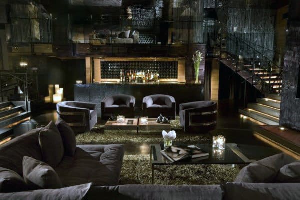 Luxurious, dimly lit bar lounge with dark furniture and elegant decor