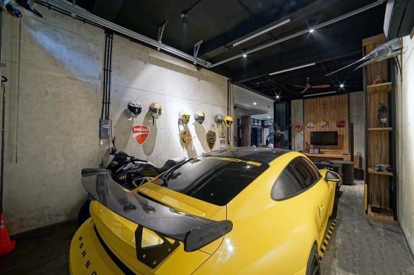man cave garage concrete wall with helmets yellow porsche
