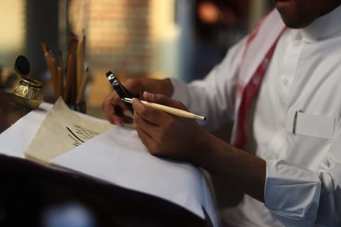 man doing calligraphy