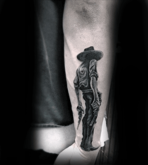 Man Holding Gun Cowboy Blackwork Tattoo On Forearm