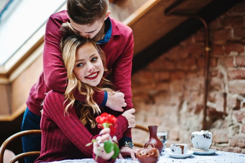 man hug his woman at the coffee shop