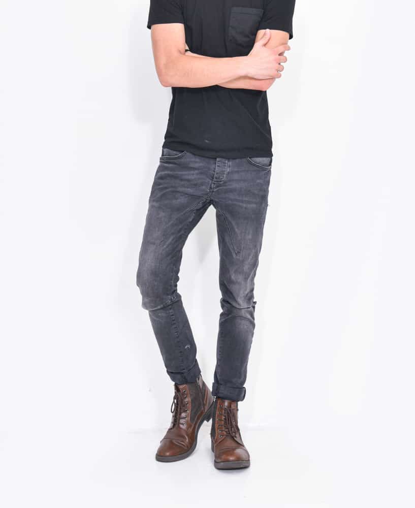 man in black t-shirts with blue jeans with brown leather shoes