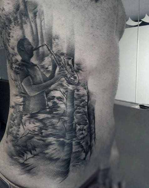 Man Playing Music Tattoo On Torso For Men