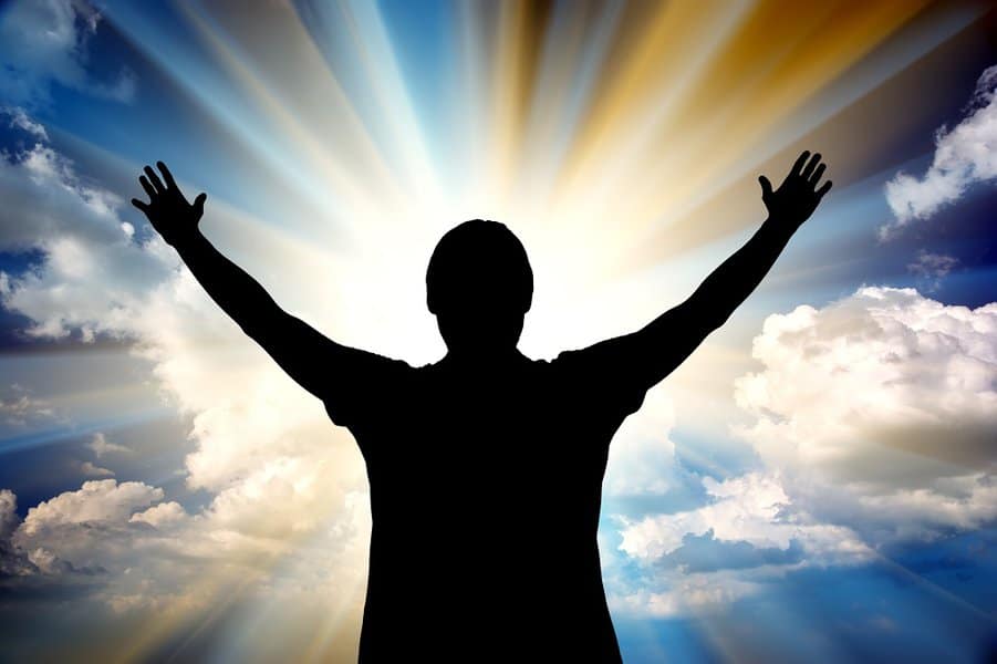 man raising hands up in the air