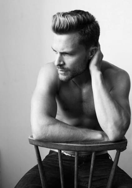 Textured, voluminous top with a clean side part and a fade